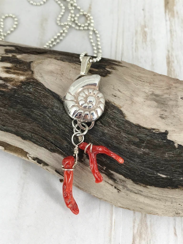 Fine silver nautilus with branch coral - a picture of the sea