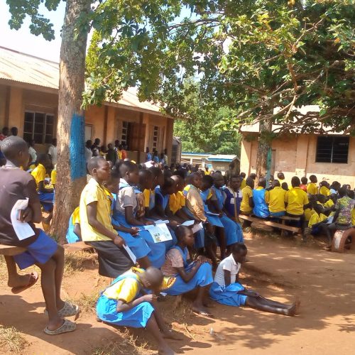 JDI staff educating the stundents of Papoga Primary schools on their Rights and reporting of child abuse in Papoga Parish, Zeu Sub County, Zombo District.